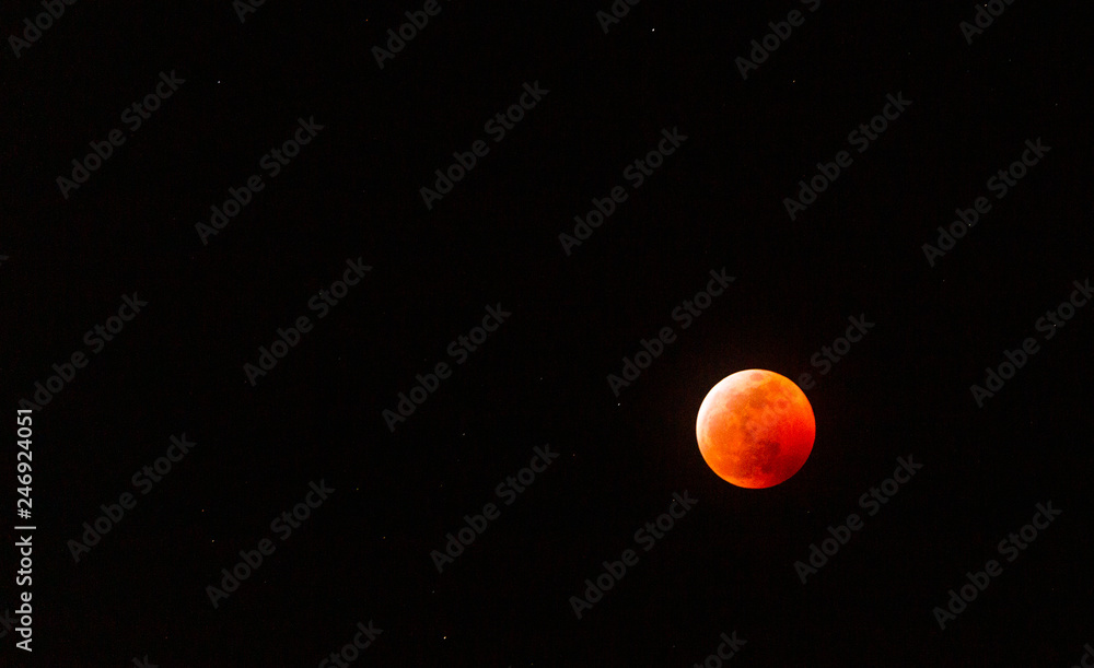 The full Lunar Eclipse in January of 2019 shows the moon in full eclipse and pictures a orangey, red moon glowing in the sky with a section on the edge with whiteish light from the glow of the sun. The full Lunar Eclipse in January of 2019 shows the moon in full eclipse and pictures a orangey, red moon glowing in the sky with a section on the edge with whiteish light from the glow of the sun.