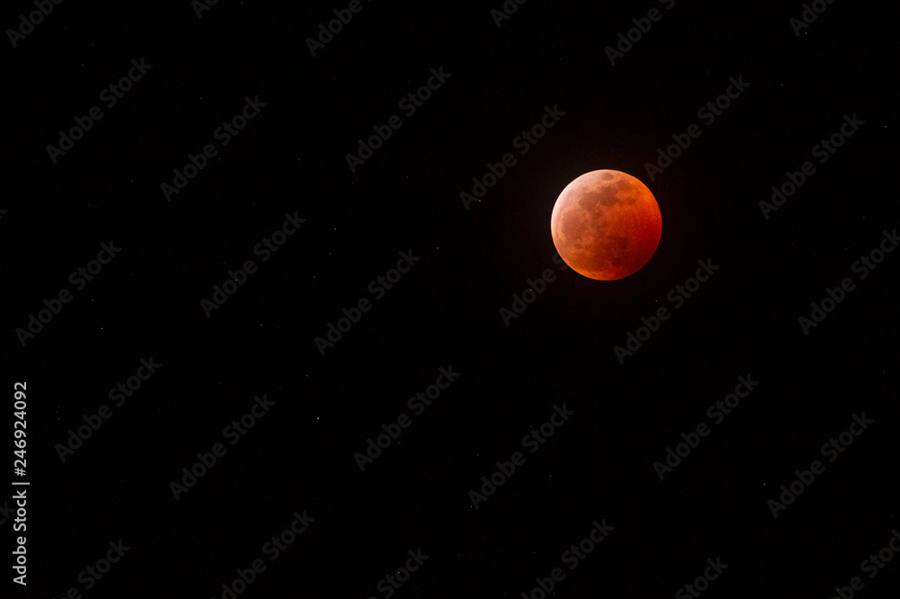 The full Lunar Eclipse in January of 2019 shows the moon in full eclipse and pictures a orangey, red moon glowing in the sky with a section on the edge with whiteish light from the glow of the sun. The full Lunar Eclipse in January of 2019 shows the moon in full eclipse and pictures a orangey, red moon glowing in the sky with a section on the edge with whiteish light from the glow of the sun.