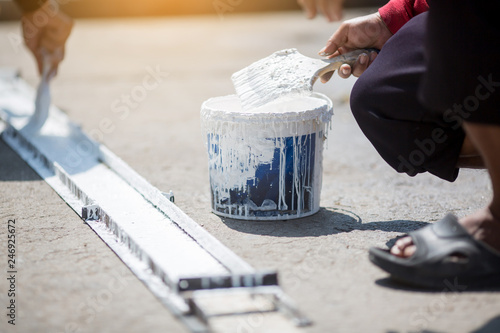 staff painting white line on floor photo