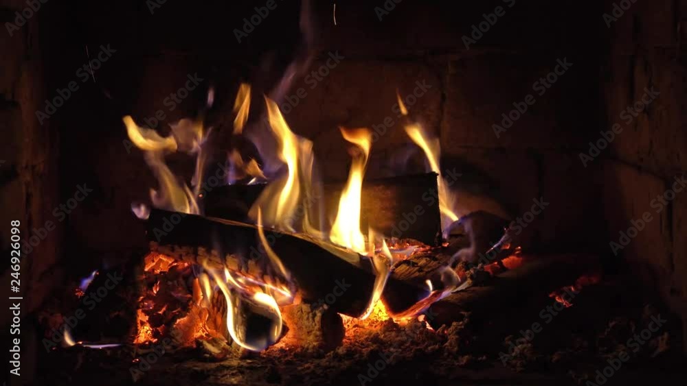 A fire burns in a brick fireplace, keep warm A fire burns in a brick fireplace, keep warm