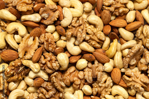 Assorted nuts background. Walnuts, almonds and cashews mixed together.