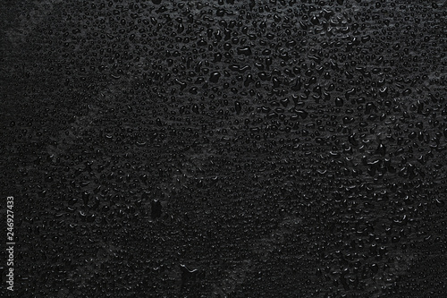 Background photo of water drops on dark stone 