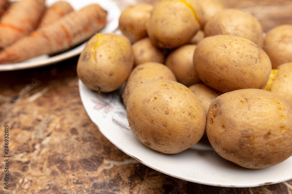 Boiled potatoes and carrots in a plate on the table Boiled potatoes and carrots in a plate on the table