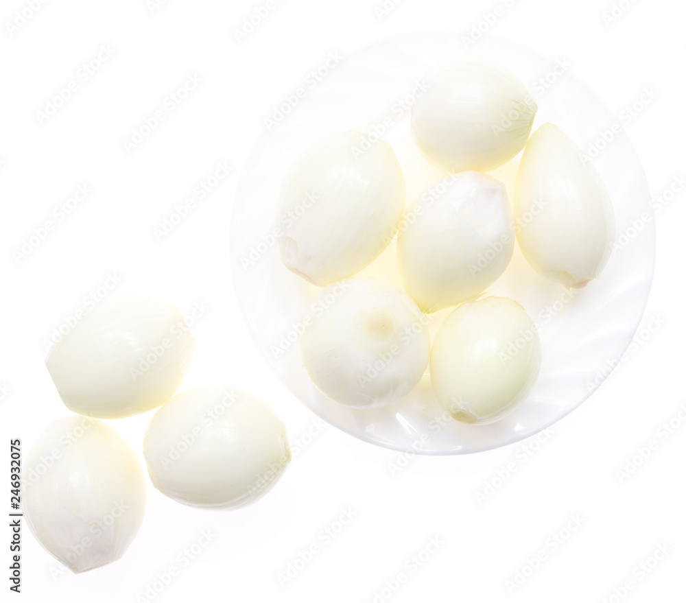 Peeled onions in a plate on a white background