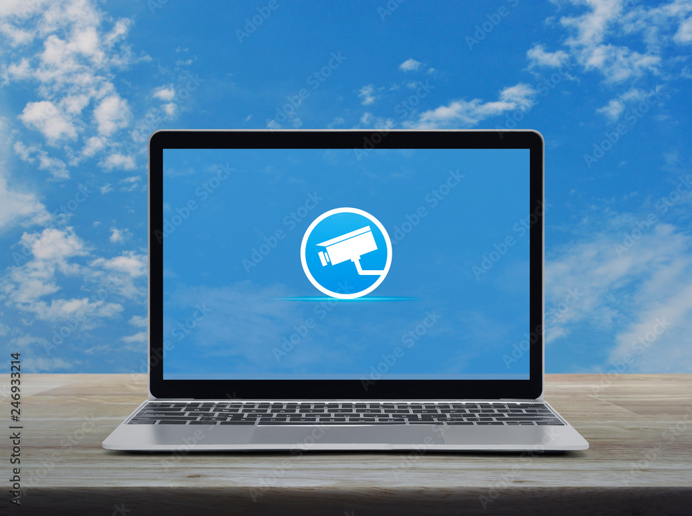 cctv camera flat icon with modern laptop computer on wooden table over blue sky with white clouds, Business security and safety online concept cctv camera flat icon with modern laptop computer on wooden table over blue sky with white clouds, Business security and safety online concept