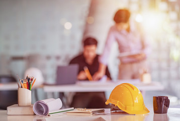 Desk of Architectural project in construction site or office with mining light.