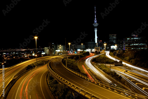 Auckland city and sky tower, skycity at night long exposure with car light trails on the highways.