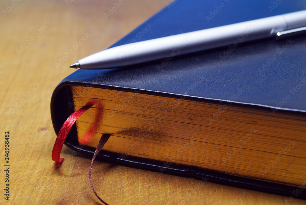 Diary and pen on desktop.