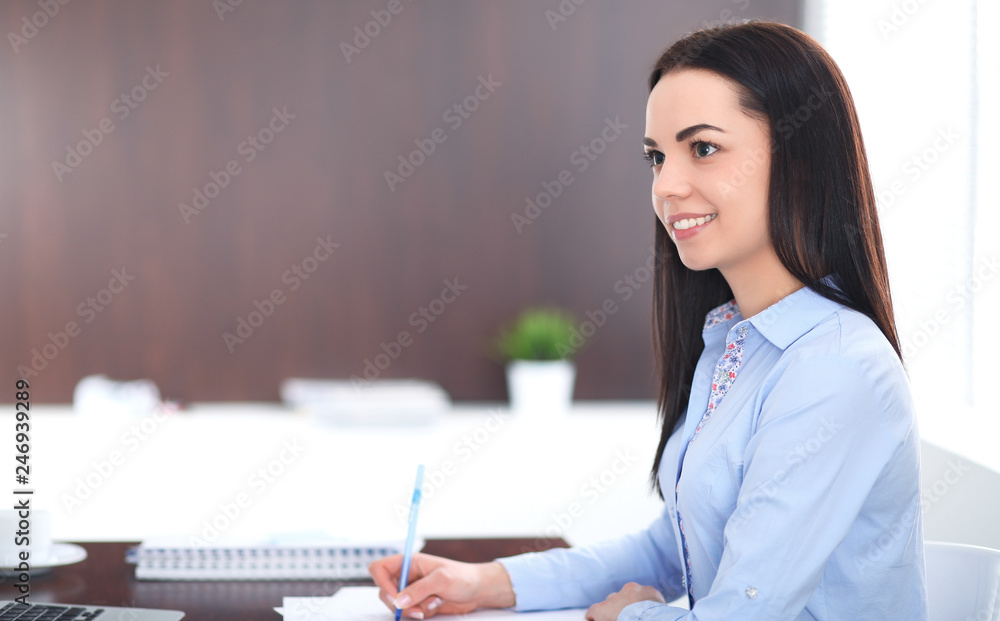 Young brunette business woman looks like a student girl working in office. Hispanic or latin american girl happy at work and too busy Young brunette business woman looks like a student girl working in office. Hispanic or latin american girl happy at work and too busy