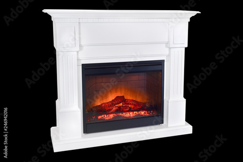 White wooden burning fireplace with roaring flames  classic elegant design. Isolated on black background  clipping path included. Fireplace as a piece of furniture