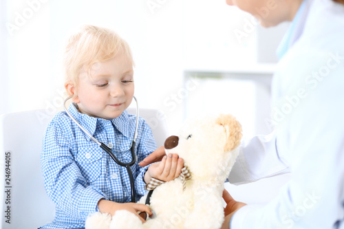 Fototapeta Naklejka Na Ścianę i Meble -  Doctor and a little blonde girl. Usual health exam. Medicine and healthcare concept