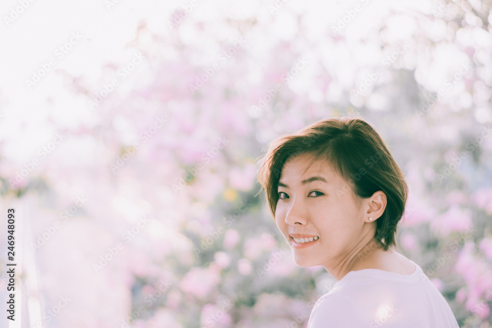 Beautiful young woman smiling with blooming cherry blossom.sakura Beautiful young woman smiling with blooming cherry blossom.sakura