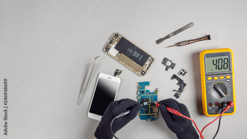 Technician or engineer using digital multimeter to electric current  measurement on smartphone logic board for diagnosis broken smartphone with  copy space Stock Photo | Adobe Stock