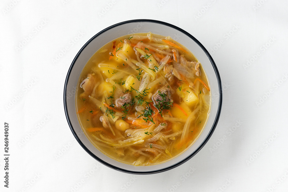 Russian cuisine. Meat soupe with vegetables - cabbage, carrot, potato. Top view Russian cuisine. Meat soupe with vegetables - cabbage, carrot, potato. Top view