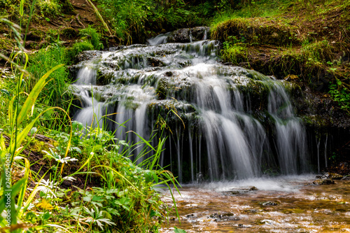 Beautiful forest stream, small waterfall 