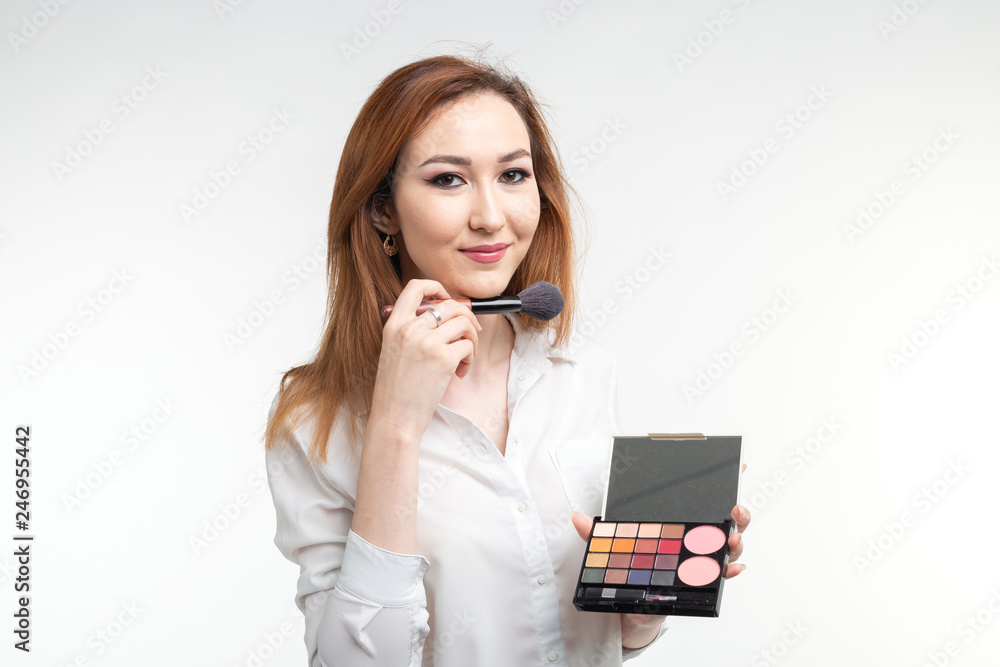 Beauty makeup artist. Close Up korean beautiful young woman pretty smiling holding eye shadow palette brush on white background Beauty makeup artist. Close Up korean beautiful young woman pretty smiling holding eye shadow palette brush on white background