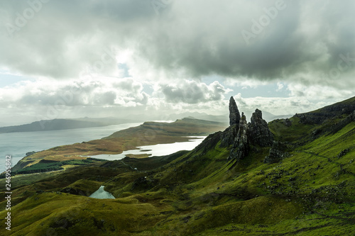 Panorama view of Old Man of Storr as seen from a higher viewpoint with dramatic clouds during autumn (Isle of Skye, Scotland, United Kingdom)