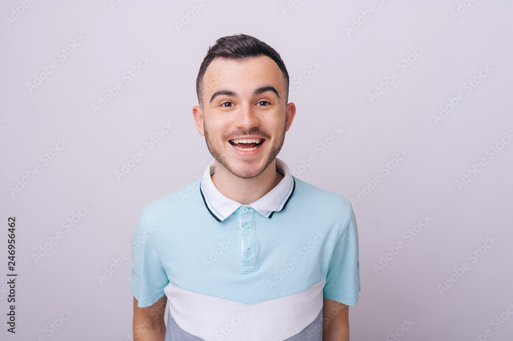 Obraz premium Young handsome man. Cheerful man laughing and looking at camera with a big grin.