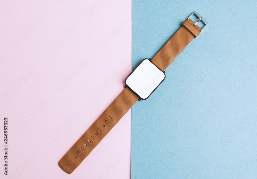 Smart Accessories, smartwatch on pink blue table. Flat lay, top view. Smart Accessories, smartwatch on pink blue table. Flat lay, top view.