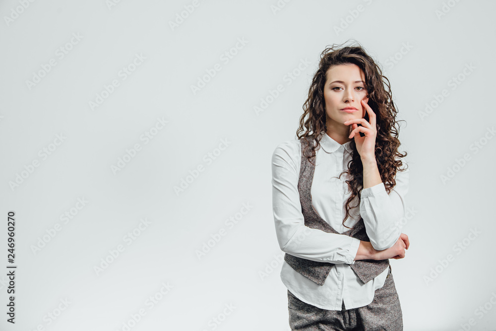 Portrait of an attractive business woman with her hand crossed a white background.