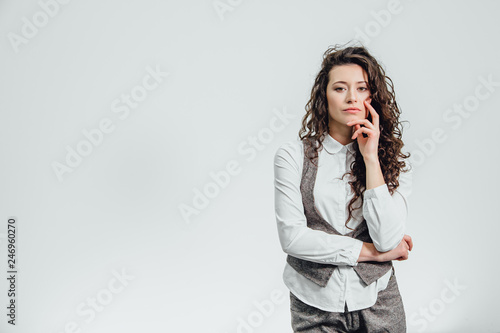 Portrait of an attractive business woman with her hand crossed a white background.