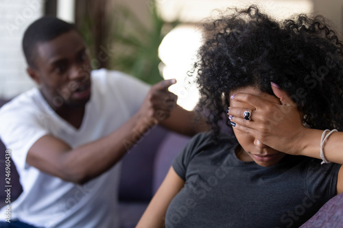 Tired frustrated african wife ignoring angry black despot husband arguing blaming upset woman of problems, jealous man shouting at sad girlfriend, family fight and controlling boyfriend, disrespect
