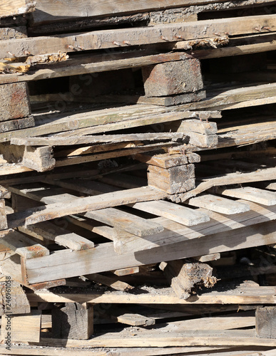 wooden planks of many old pallets used to transport the goods photo