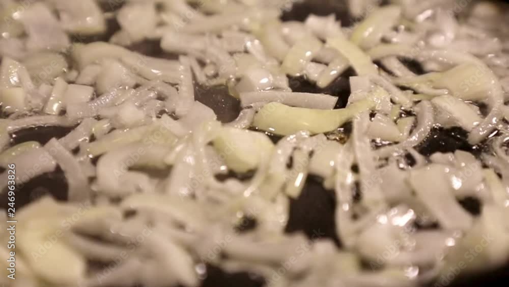 Onions fried in a frying pan with oil. Onions fried in a frying pan with oil.