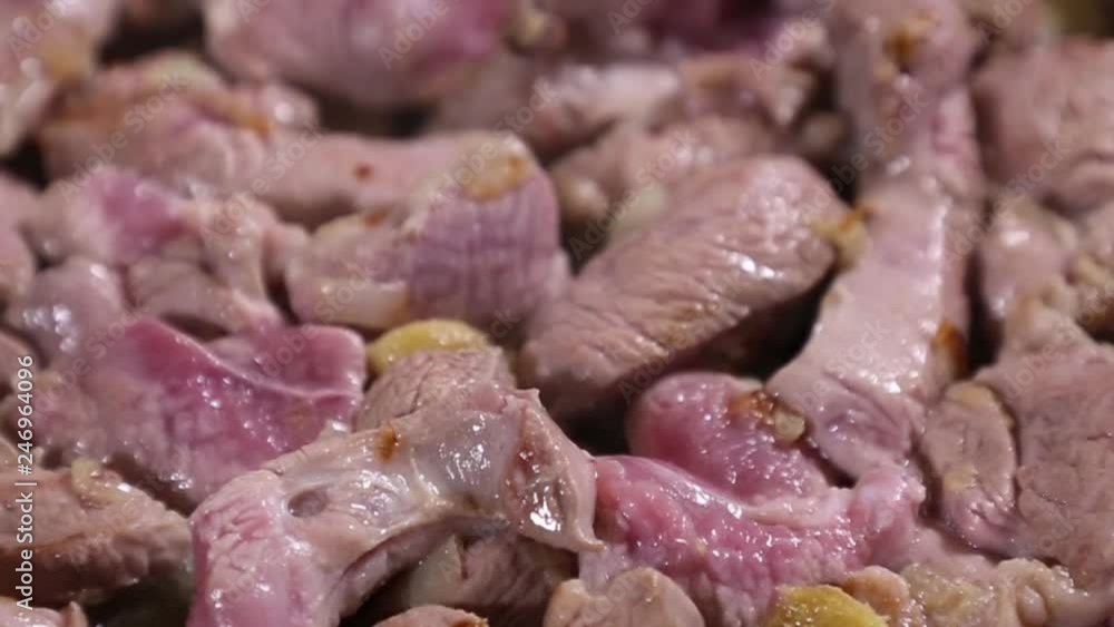 Pieces of Turkey meat or chicken meat are fried in a pan with garlic and onions. Pieces of Turkey meat or chicken meat are fried in a pan with garlic and onions.