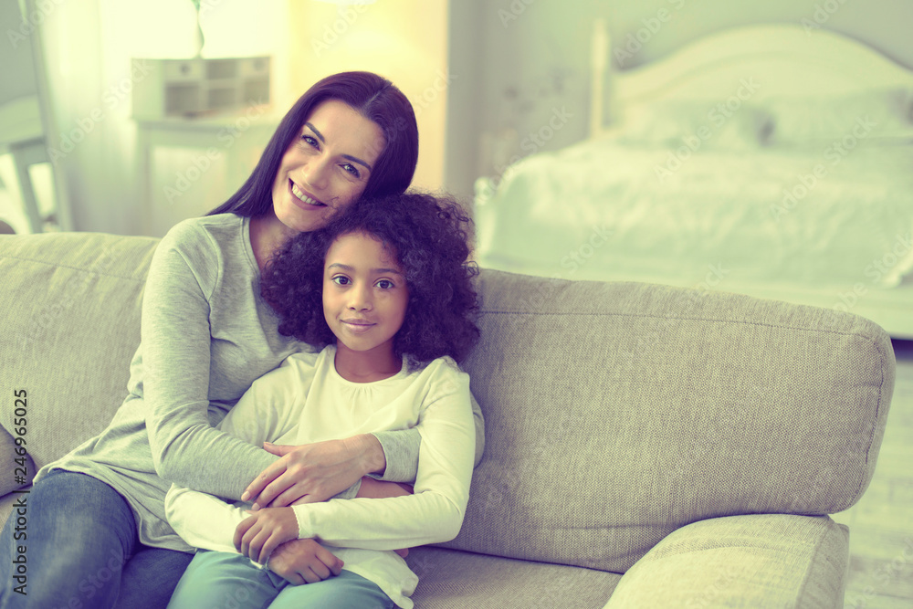 Caucasian woman and her adopted brown daughter posing for the picture. Caucasian woman and her adopted brown daughter posing for the picture.