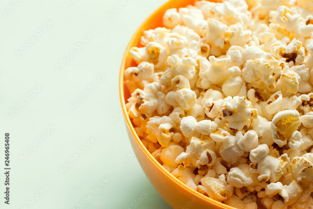 An orange bowl with popcorn isolated An orange bowl with popcorn isolated
