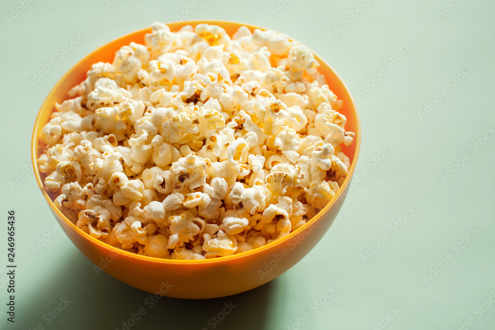 An orange bowl with popcorn isolated An orange bowl with popcorn isolated