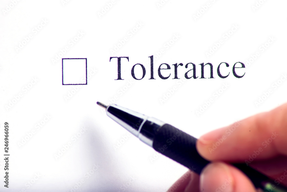 Tolerance - checkbox with a cross on white paper with pen. Checklist concept. Tolerance - checkbox with a cross on white paper with pen. Checklist concept.