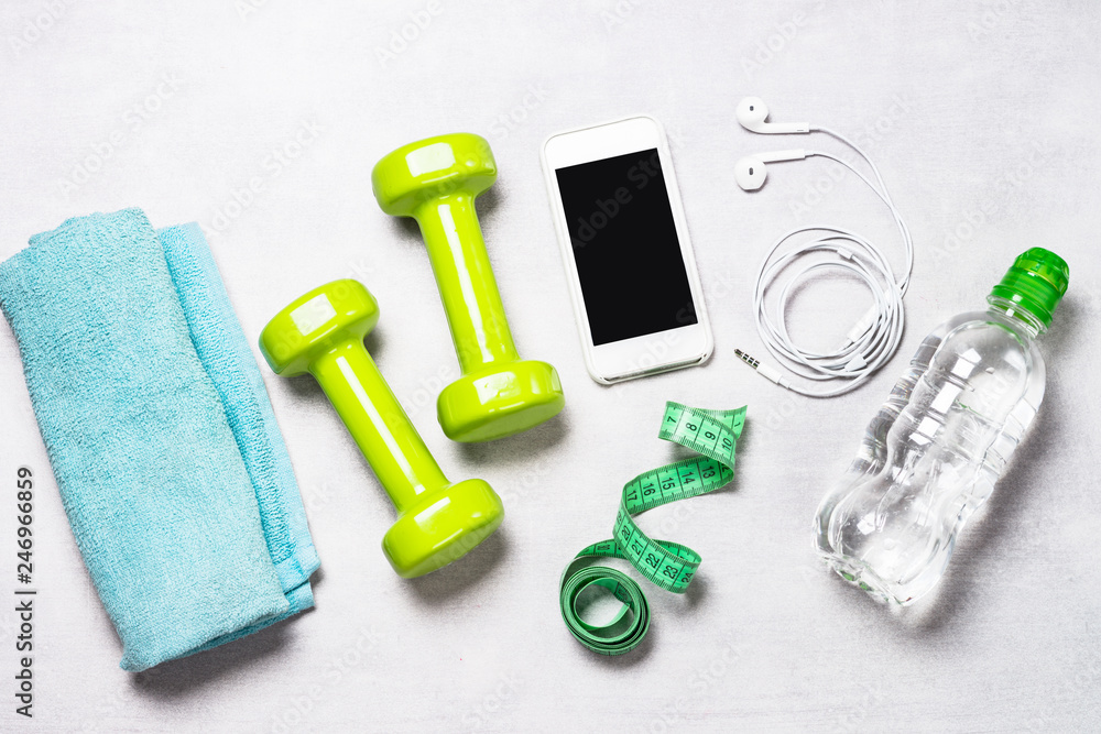 Dumbbells, measuring tape, water and apple top view. Dumbbells, measuring tape, water and apple top view.