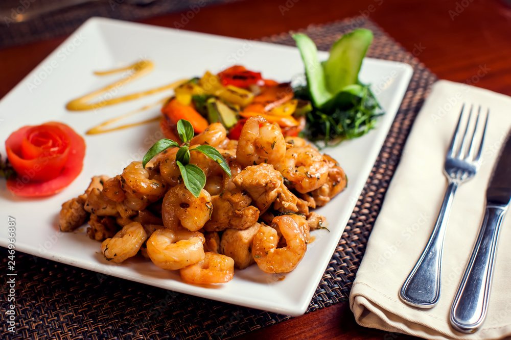 Chicken Marengo - French dish consisting of a chicken and shrimps with garlic and tomato. Food and restaurant concept Chicken Marengo - French dish consisting of a chicken and shrimps with garlic and tomato. Food and restaurant concept
