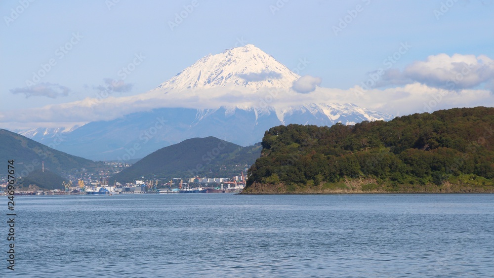 Koryaksky volcano towers over the city of Petropavlovsk-Kamchatsky. Koryaksky or Koryakskaya Sopka is an active volcano on the Kamchatka Peninsula in the Russian Far East. Koryaksky volcano towers over the city of Petropavlovsk-Kamchatsky. Koryaksky or Koryakskaya Sopka is an active volcano on the Kamchatka Peninsula in the Russian Far East.