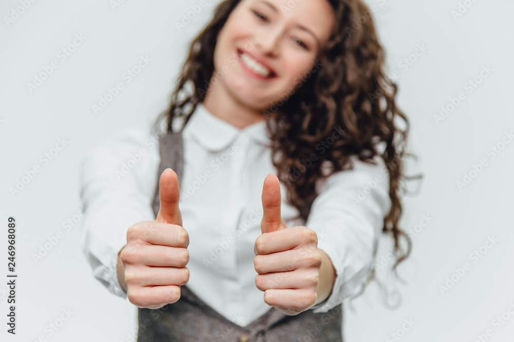 Young business lady with beautiful curly hair on a white background rejoices. During this, the gesture class shows Young business lady with beautiful curly hair on a white background rejoices. During this, the gesture class shows