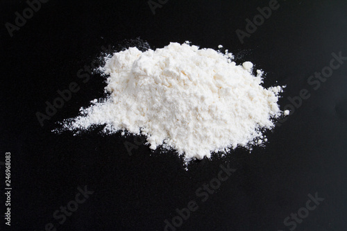  white flour on a black background in a handful