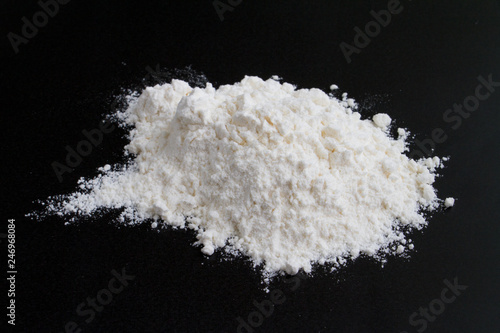  white flour on a black background in a handful