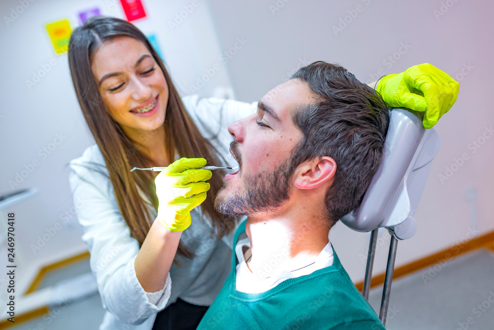 My dentist is the best! Portrait of a female dentist and young man in a dentist office