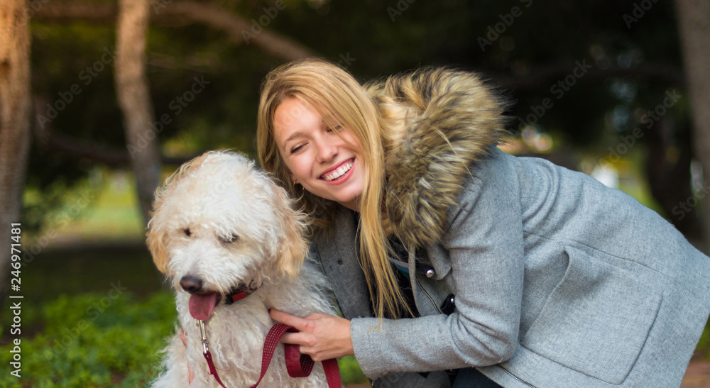 Young girl with her dog in a park Young girl with her dog in a park