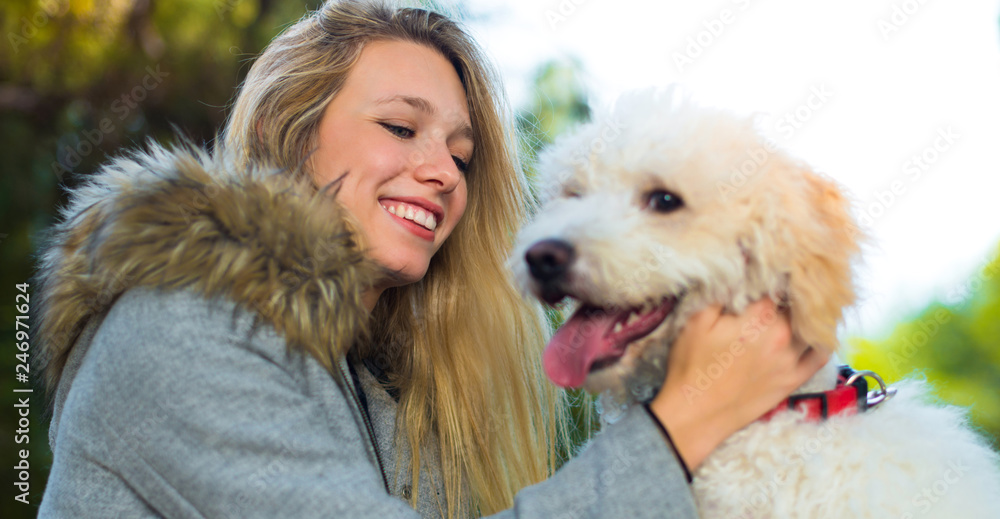 Young girl with her dog in a park Young girl with her dog in a park