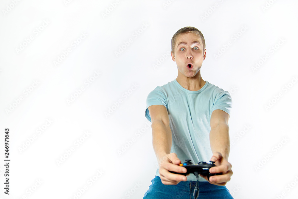 emotional man playing video game, with console joystick in his hand on a light background emotional man playing video game, with console joystick in his hand on a light background