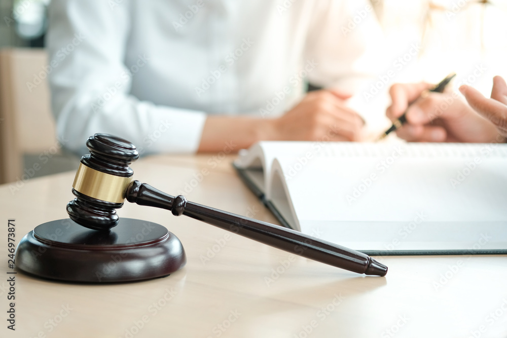 Legal counsel presents to the client a signed contract with gavel and legal law. justice and lawyer concept. Legal counsel presents to the client a signed contract with gavel and legal law. justice and lawyer concept.