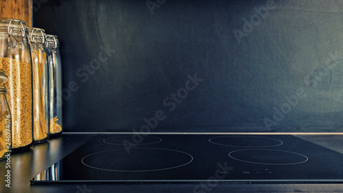 Modern black kitchen with induction cooktop