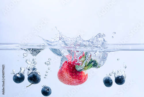 Strawberry and Blueberries Splashing in Water