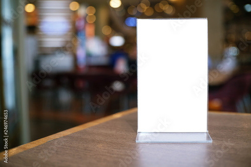 Menu frame standing on wood table in Bar restaurant cafe. space for text marketing promotion.