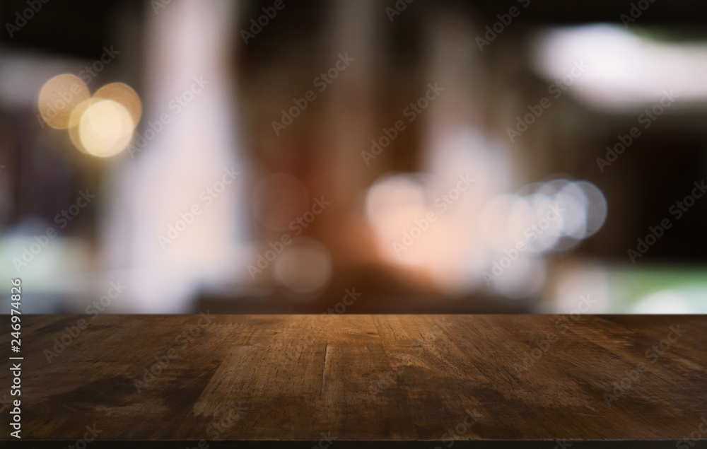 Empty dark wooden table in front of abstract blurred bokeh background of restaurant . can be used for display or montage your products.Mock up for space.