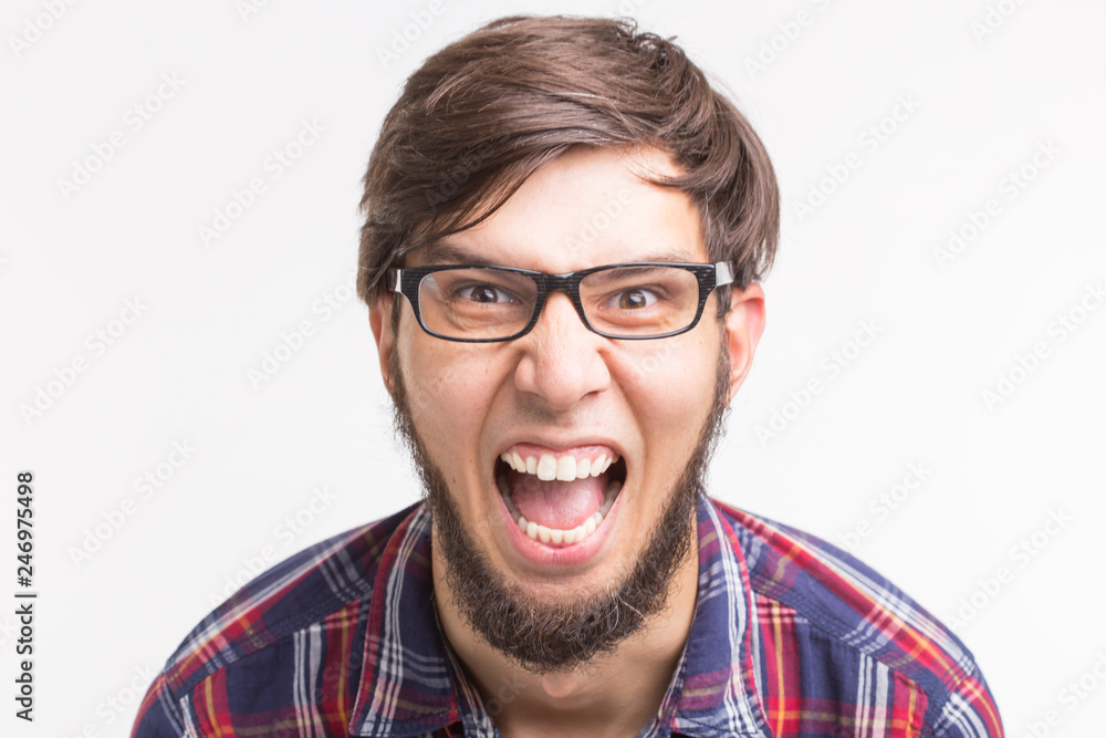 Expression and gesture concept - Portrait of angry man screaming on white background Expression and gesture concept - Portrait of angry man screaming on white background