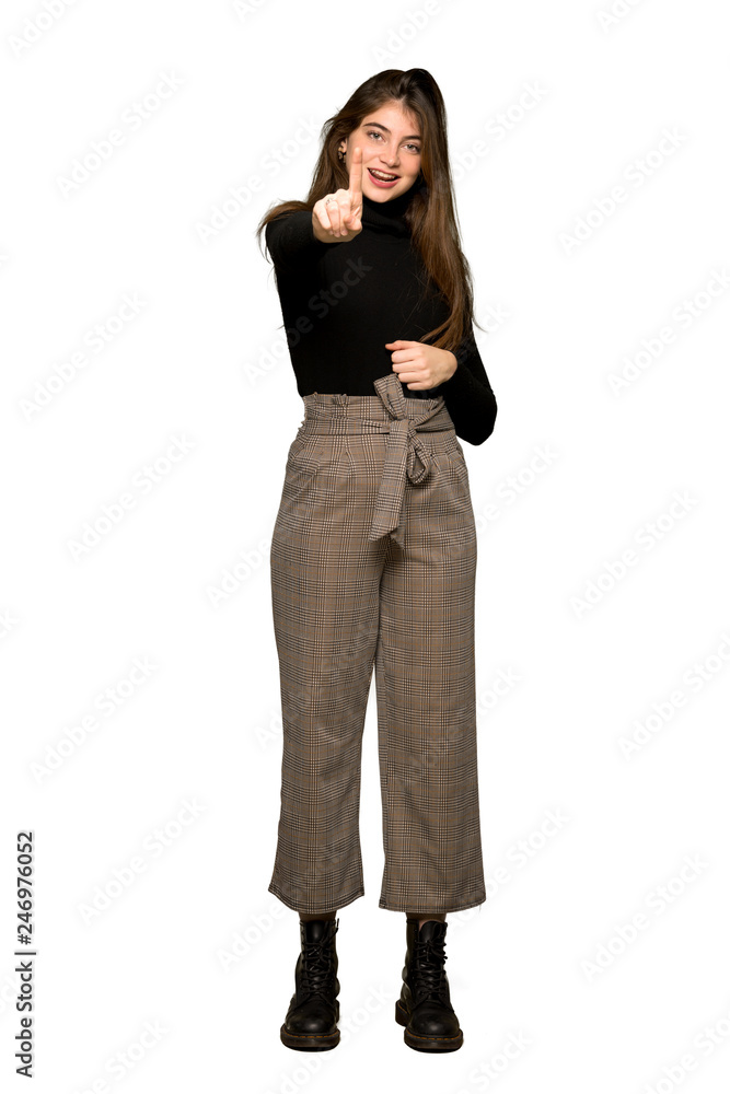 Full-length shot of Pretty girl showing and lifting a finger on isolated white background Full-length shot of Pretty girl showing and lifting a finger on isolated white background